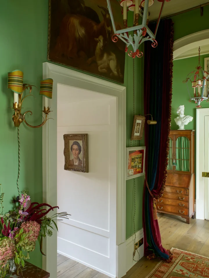 British maximalism elegant country green hallway with antique scones