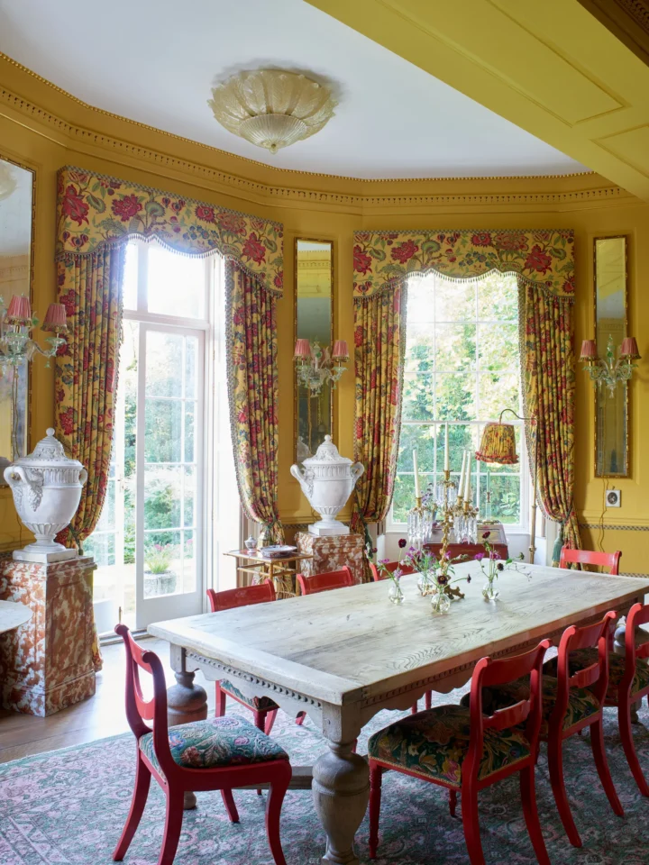 maximalism traditional elegant yellow and red dining room with Curtains of a Braquenié toile 