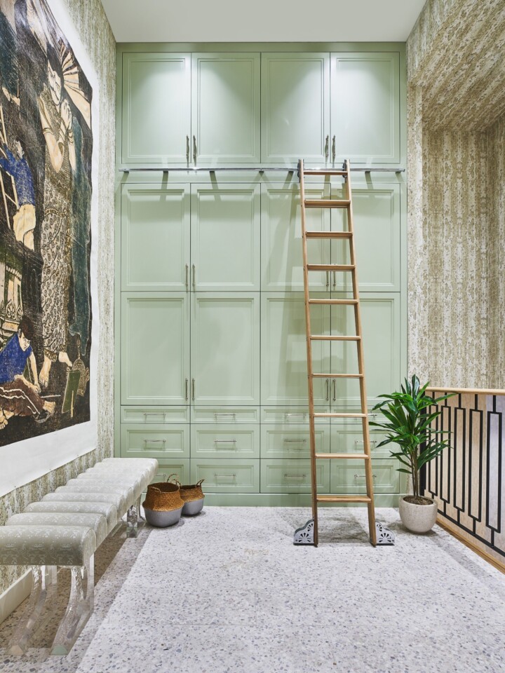 mudroom with pistachio-green cabinets and vintage library ladder