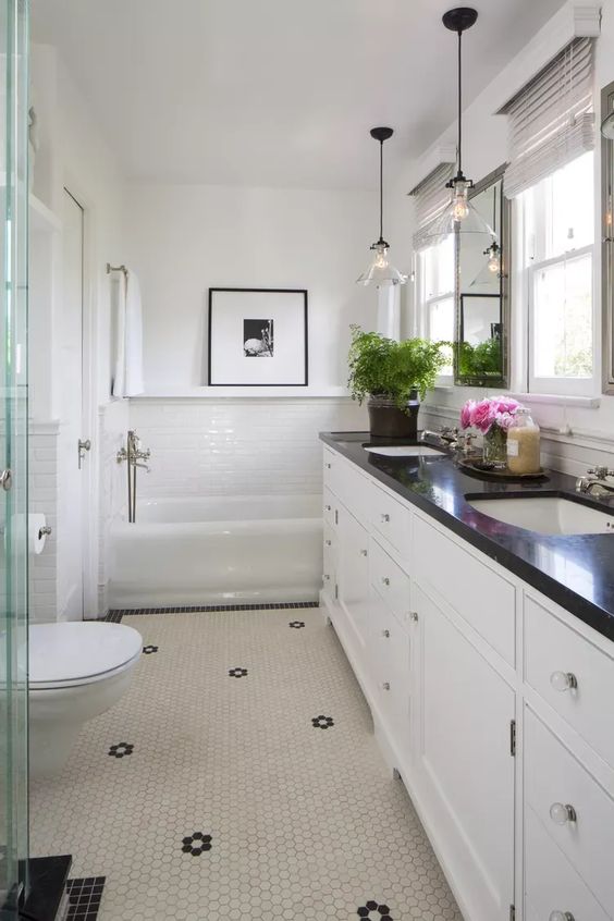 Bathroom with white hexagon tiles and black countertops