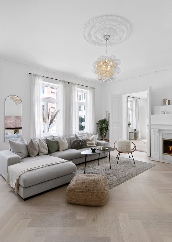 Scandinavian living room with  herringbone floors and grey sectional sofa