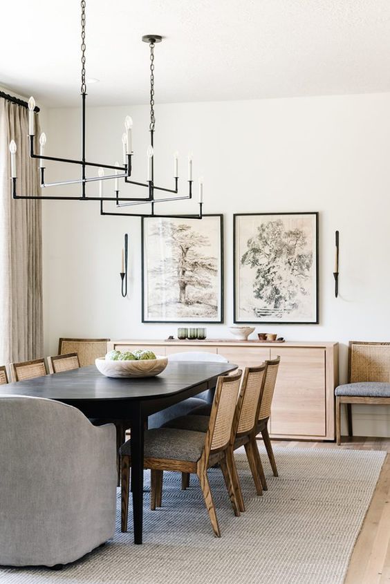 dining room with mix of wood tones and inear chandeliers hang above an oval the dark wood dining table