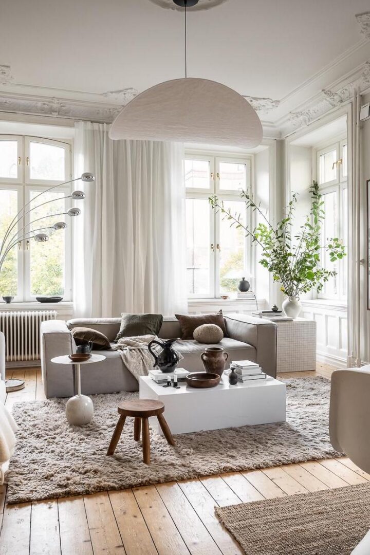 Modern Scandinavian living room with modern deep seat low gray sofa modern white coffee table and large white lamp lamp mad by bamboo paper