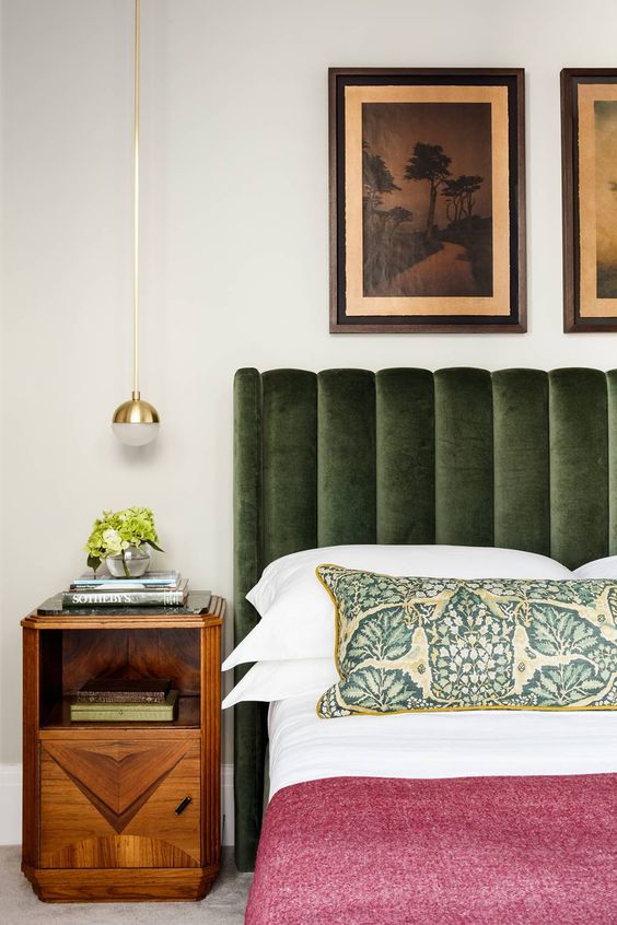 eclectic bedroom with dark green velvet chanel heatboard