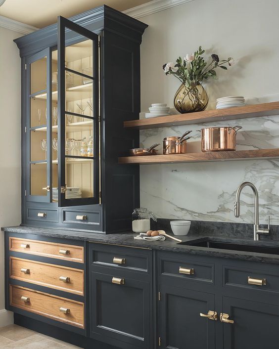 elegant country kitchen with mixed metals, dark and natural oak cabinets with brass accents and silver faucet.