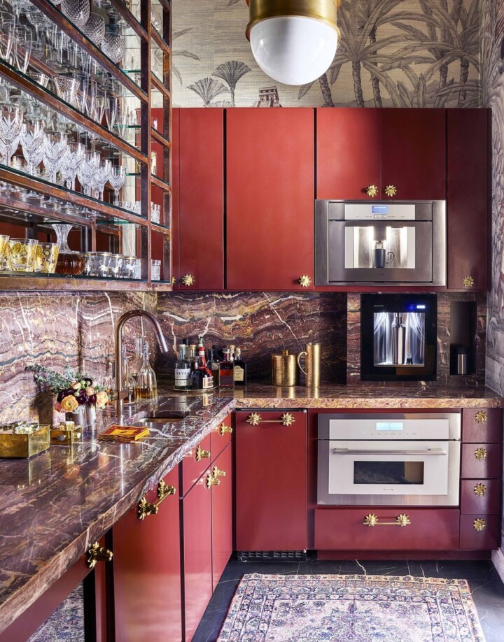 kitchen with red cabinets gold jandles and silver faucet and appliances