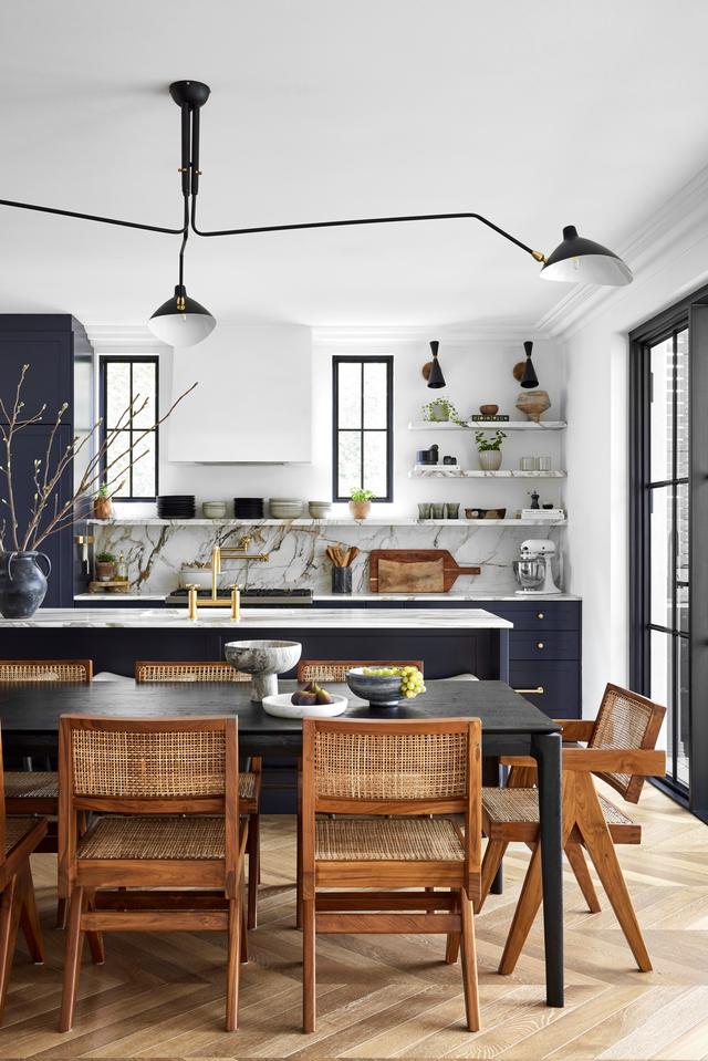 kitchen with marble shelves and navy blue black cabinets