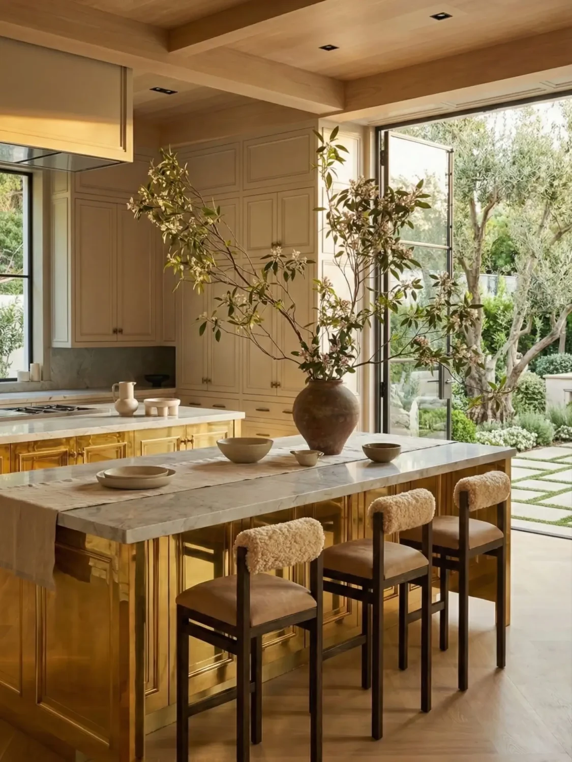 Warm neutral kitchen with pale wood cabinets and unlacquered brass details