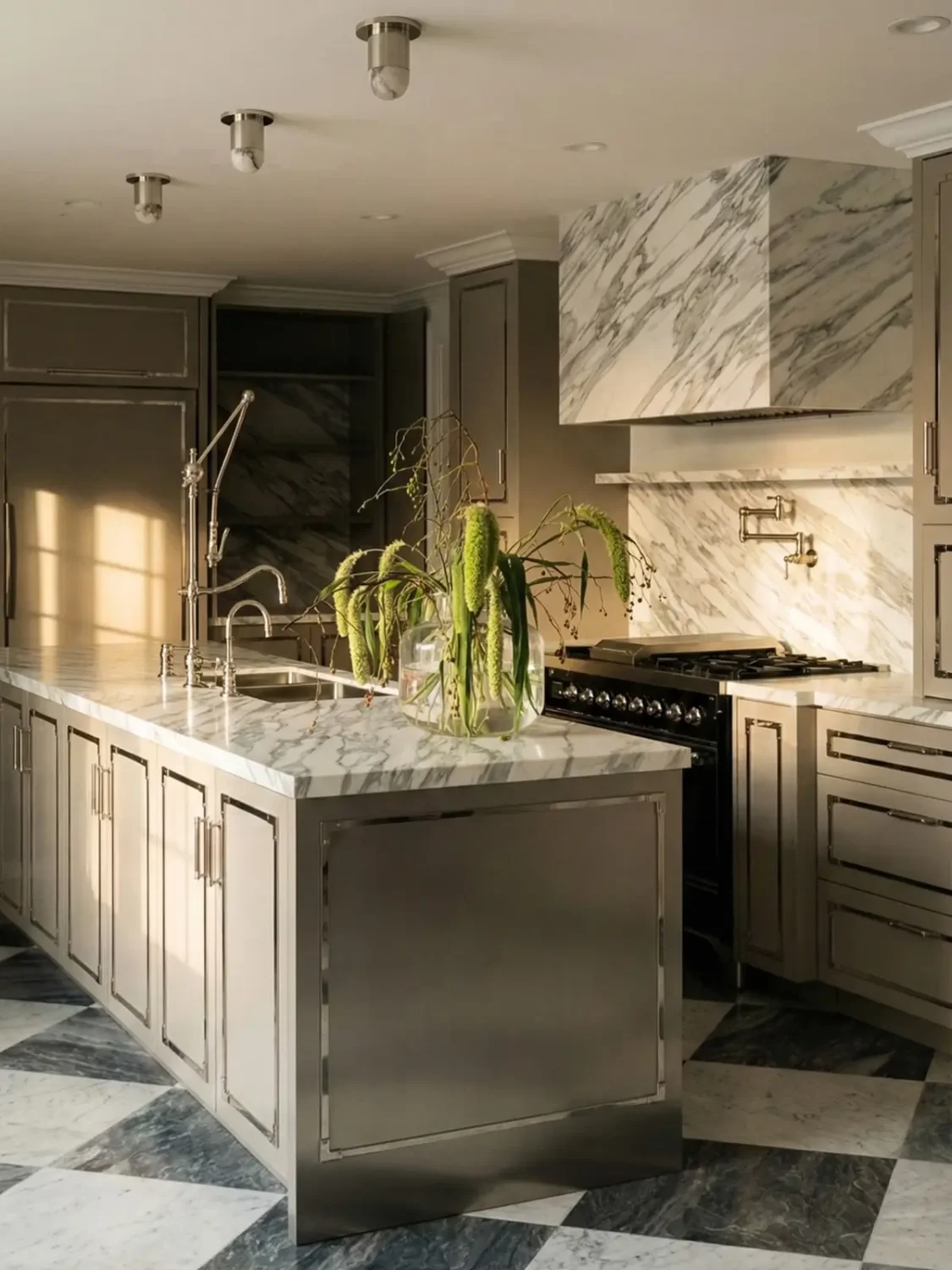 Modern kitchen with bold marble veining, metal finishes, and soft ambient lighting