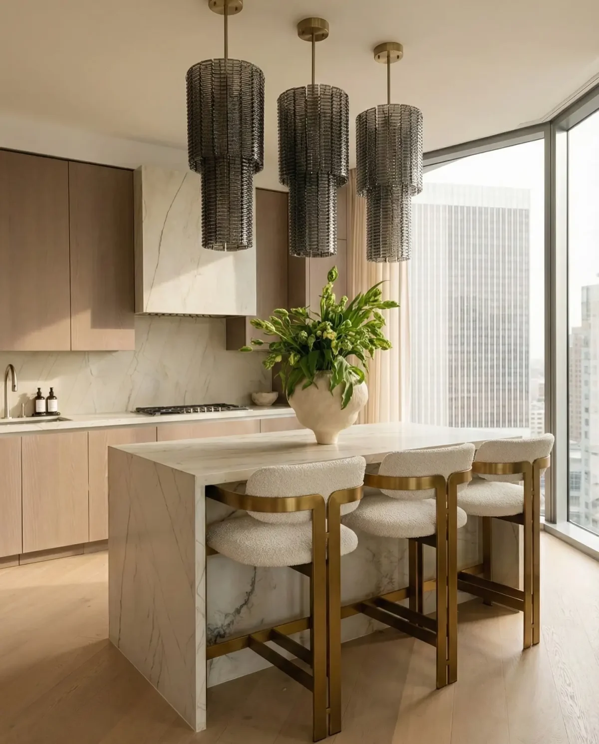 Designer kitchen with sculptural island and statement pendant lighting