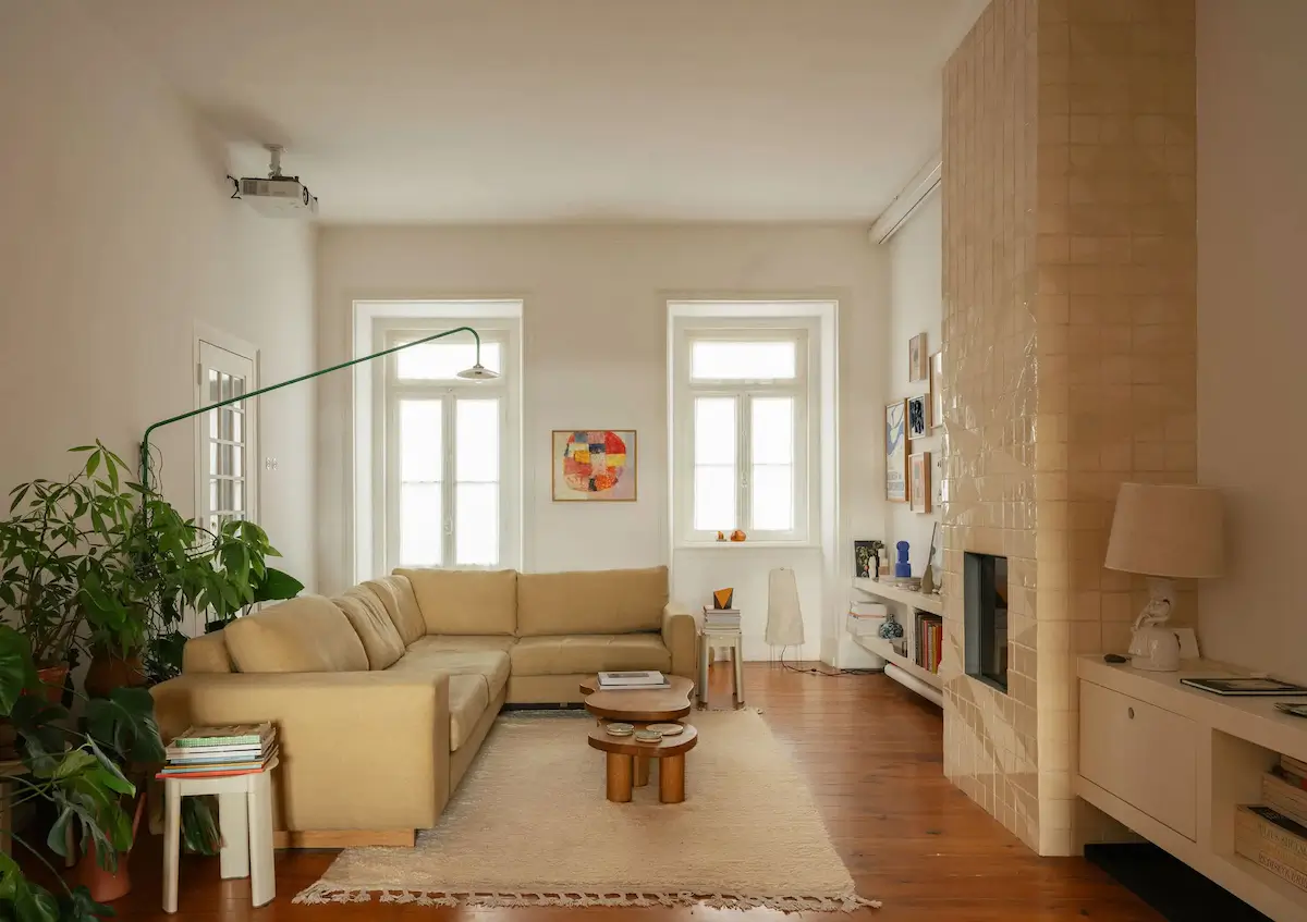 A handmade tiled fireplace anchors the calm and collected living room.