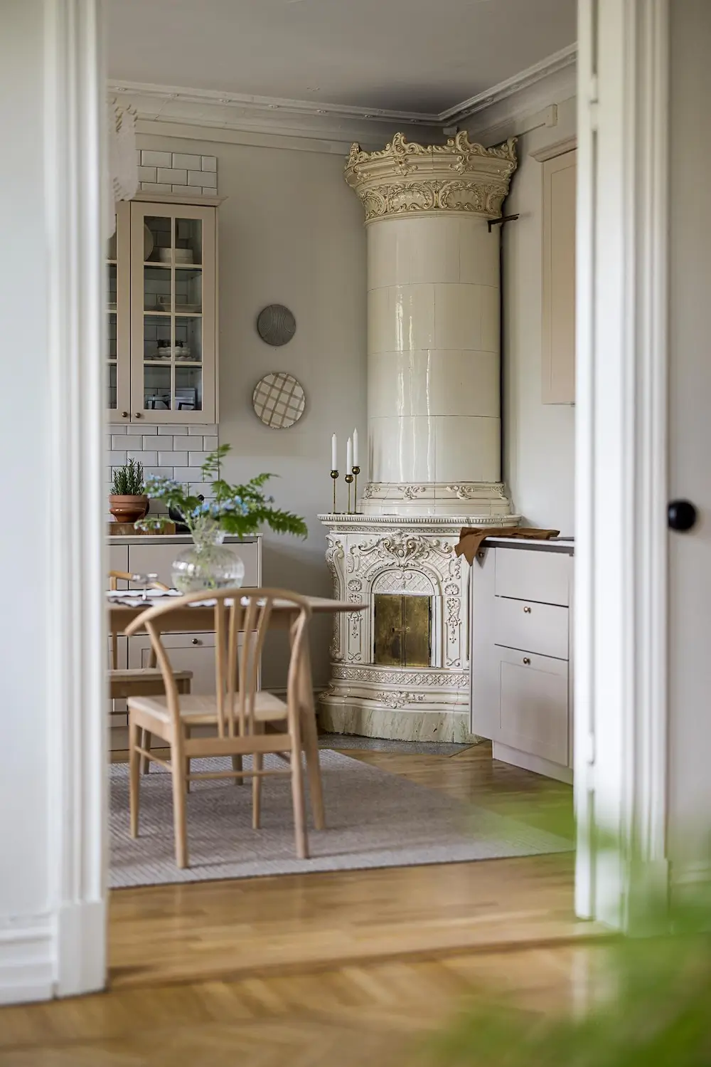 Historic Swedish ceramic tile stove in a Scandinavian kitchen.